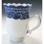 An 18th century blue and white mug, possibly soft paste, the bell shape painted with three