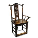A yoke back arm chair, possibly late Ming, the vertical back panel pierced and carved with a