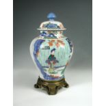 A late 19th/early 20th century wucai jar, cover and ormolu stand, the baluster body painted with