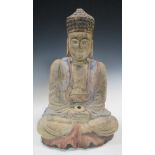 A 19th century carved wood figure of the Buddha, possibly Burmese, seated with his legs crossed,