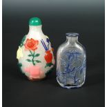 Two glass overlay snuff bottles, that with snow misted ground applied with coloured Buddhist