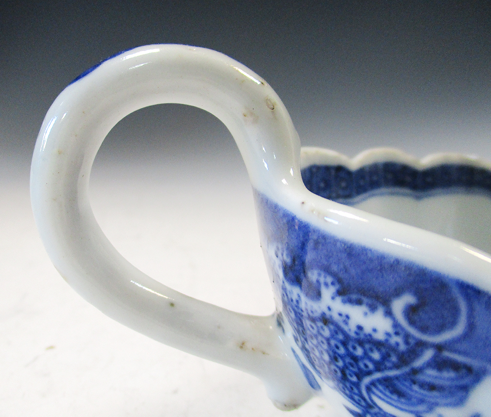 An 18th century blue and white sauce boat, the fluted rim with corallite band enclosing a scene - Image 2 of 4