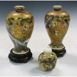 Hotoda, a pair of Satsuma vases, wood stands and a vegetable ivory snuff bottle, the baluster
