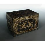 A 19th century black lacquer tea caddy, the rectangular hinged lid gilt with lotus scrolls, the