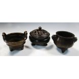 Three cupro-bronze censers, all supported on three feet, those with bamboo and mask handles