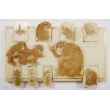 An ivory whist marker carved with monkeys, the ivory rectangle with three monkeys in relief, the