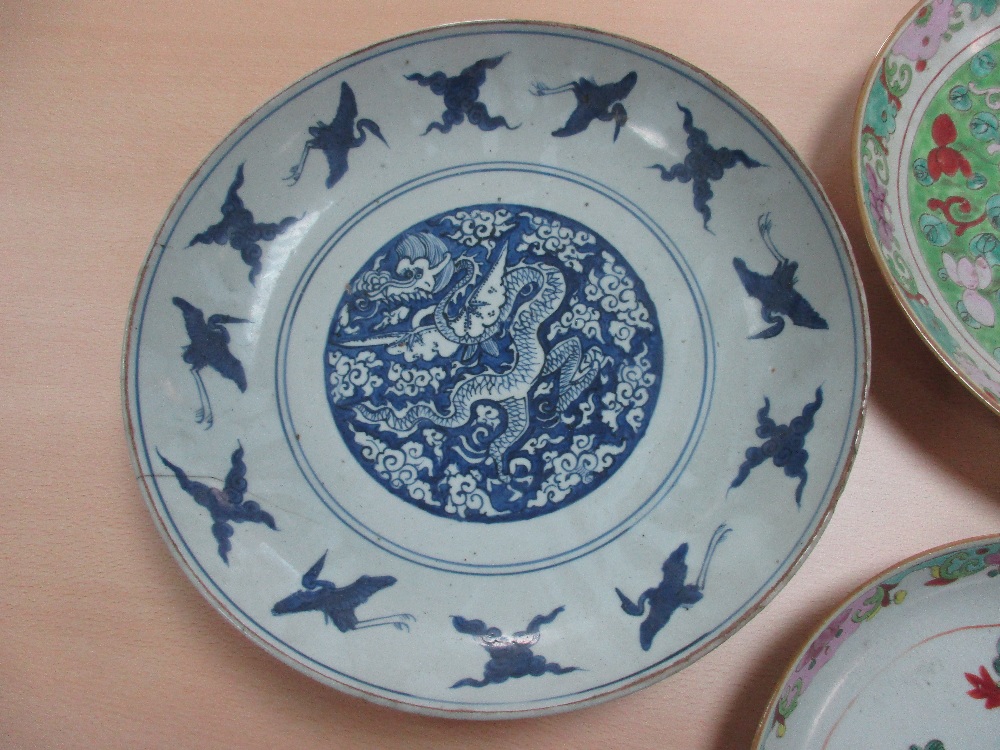 Two 19th century Canton dishes and an earlier blue and white dish, the centre of the smaller - Image 2 of 7