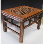 An 18th/19th century elm stool, the rectangular seat criss-crossed with leather straps, the