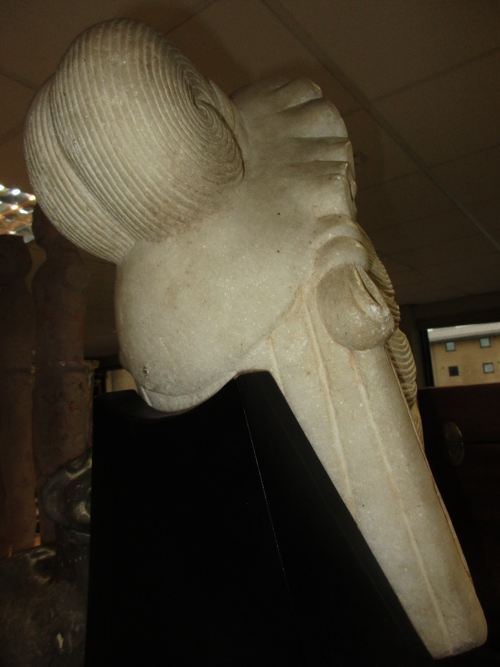 A late 19th/early 20th century white marble head of Guanyin, her headdress centred by a rosette - Image 3 of 3