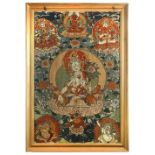 A Tibetan needlework tankha, the white Tara enthroned centrally within a pink halo and flowers,