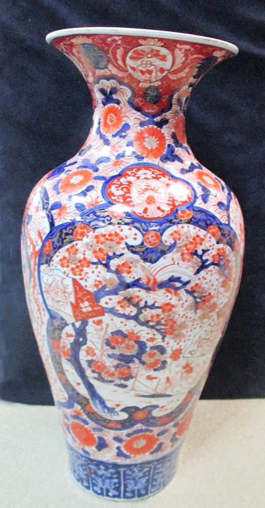 A late 19th/early 20th century Imari vase, the baluster shape with two garden reserves in lobed blue