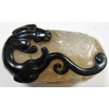 A shadow agate pendant, the grey sides of the hollowed oval body pierced and carved as stylised