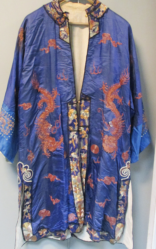 A blue silk jacket embroidered in metal thread with three four clawed dragons amongst clouds, the