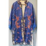 A blue silk jacket embroidered in metal thread with three four clawed dragons amongst clouds, the