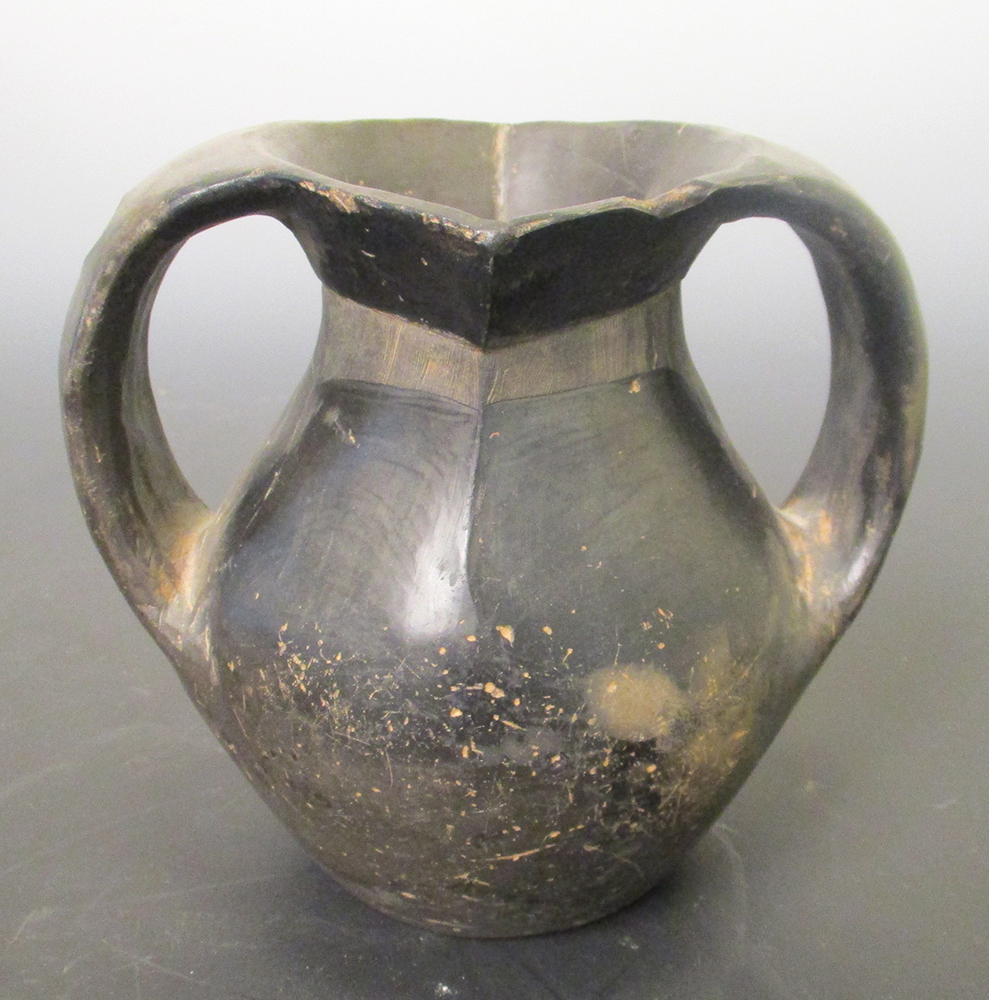 A Han dynasty grey pottery vase, the strap handles applied from the rim to the girth of the ovoid