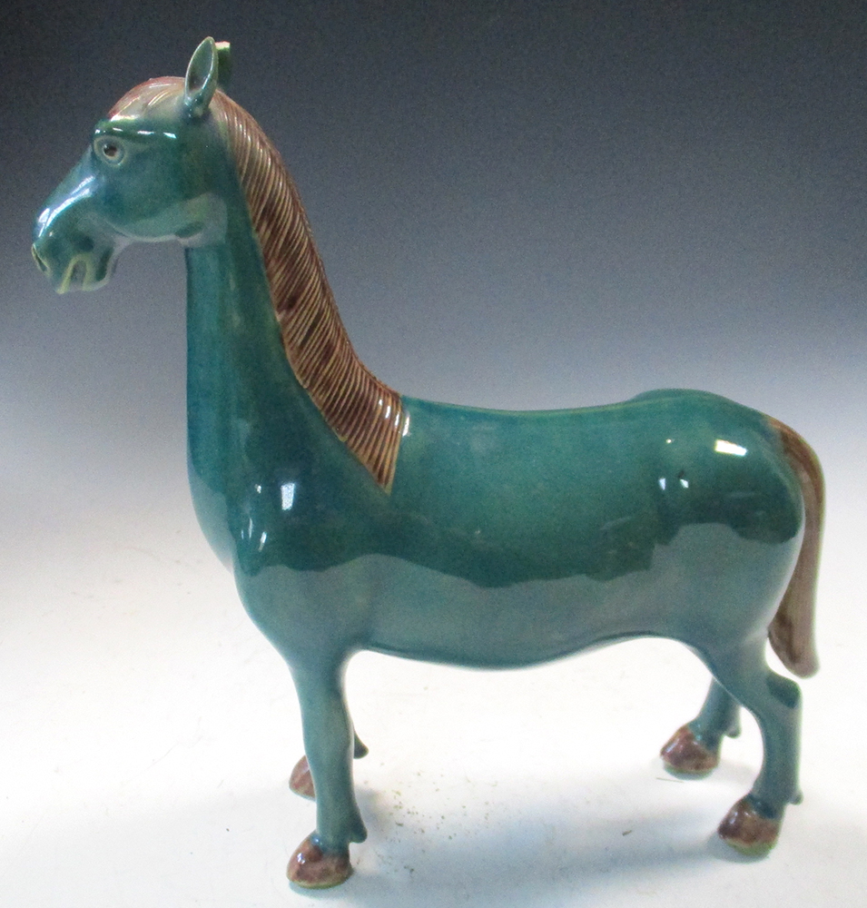 A 20th century turquoise glazed horse standing four square, its mane, tail and hooves glazed