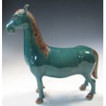 A 20th century turquoise glazed horse standing four square, its mane, tail and hooves glazed