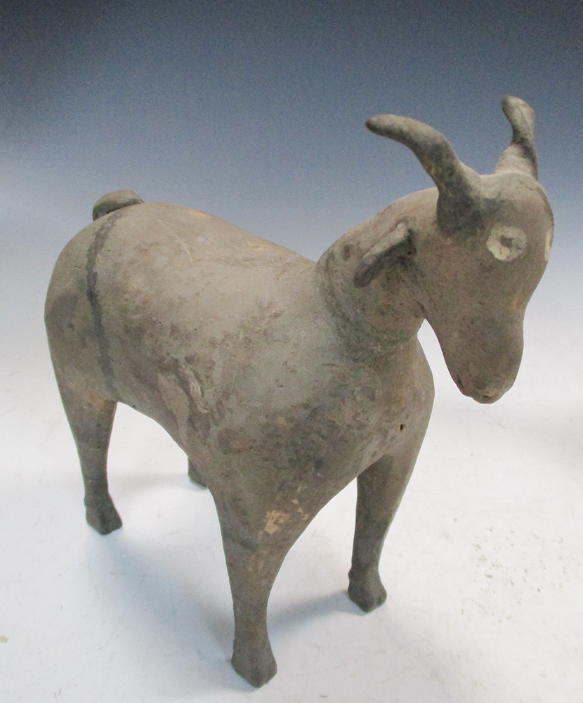 A pair of Han dynasty grey pottery goats, each characterful figure standing four square, its eyes - Image 4 of 7