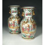 A pair of Canton vases, the petal edged everted rims above gilt lion handles and pairs of dragons on