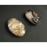 A clear rock crystal pendant, the flattened ovoid sides of the hollowed form pierced and carved with