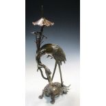 A bronze crane and tortoise pricket candlestick, the removable nozzle in the form of lotus held in