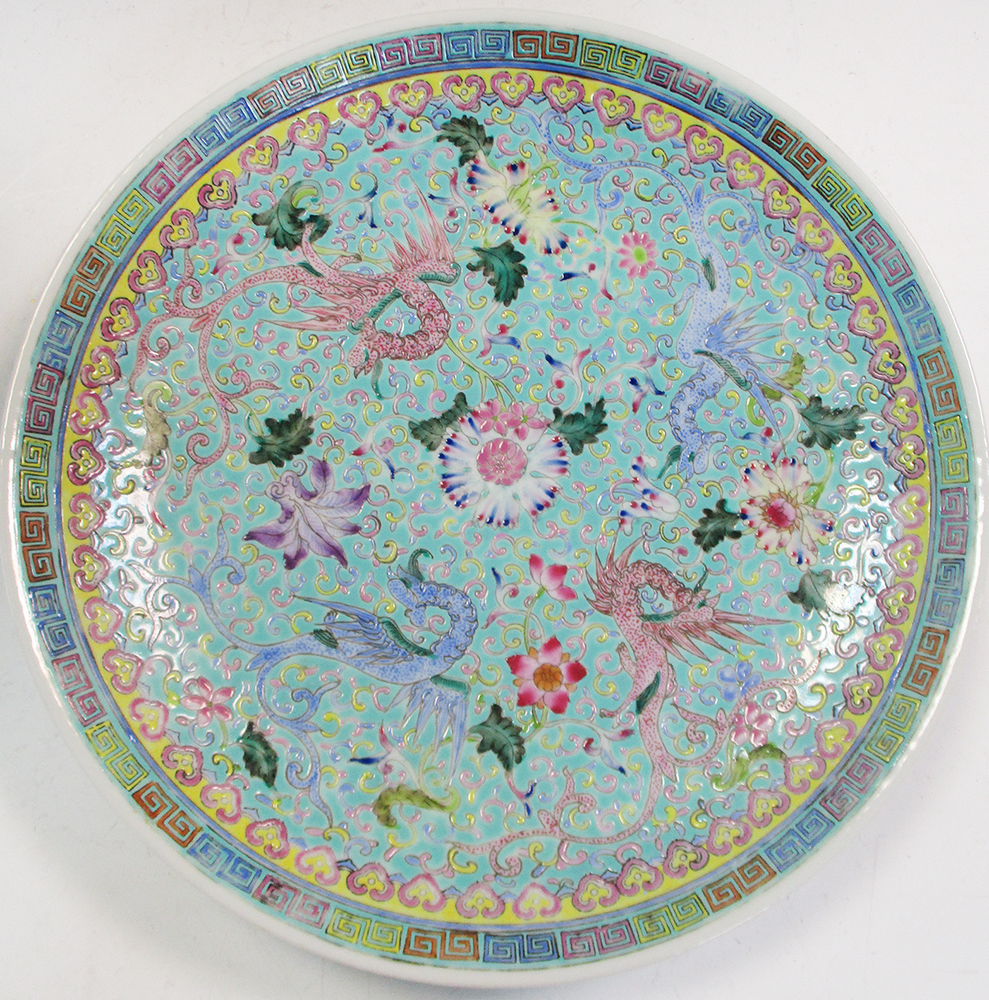 A 20th century turquoise ground dish, the alternating pink and blue dragons radiating about a