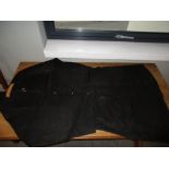 A 19th century black satin silk surcoat, the weave to include damask roundels of twinned four clawed