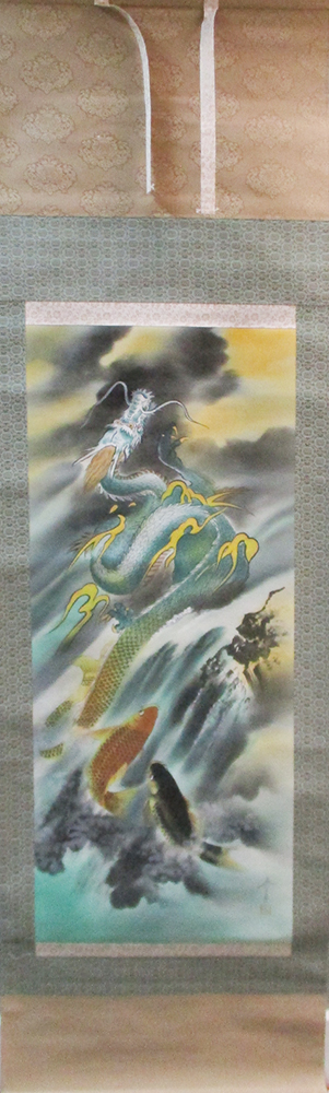 A 20th century scroll painting depicting a dragon and two carp rising from the sea into a stormy sky