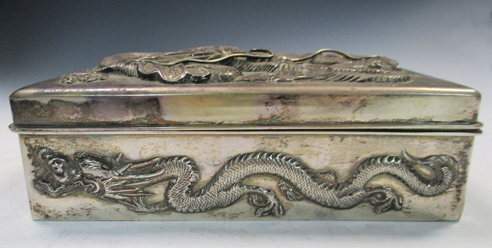 An early 20th century silver double cigarette box, the rectangular hinged lid and sides cast in - Image 3 of 6