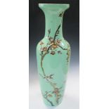 A Republic period green ground vase, the slender baluster shape painted with a bird perched on a