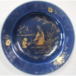 An 18th century blue ground plate gilt with a lady and child within a fenced garden, the rim with