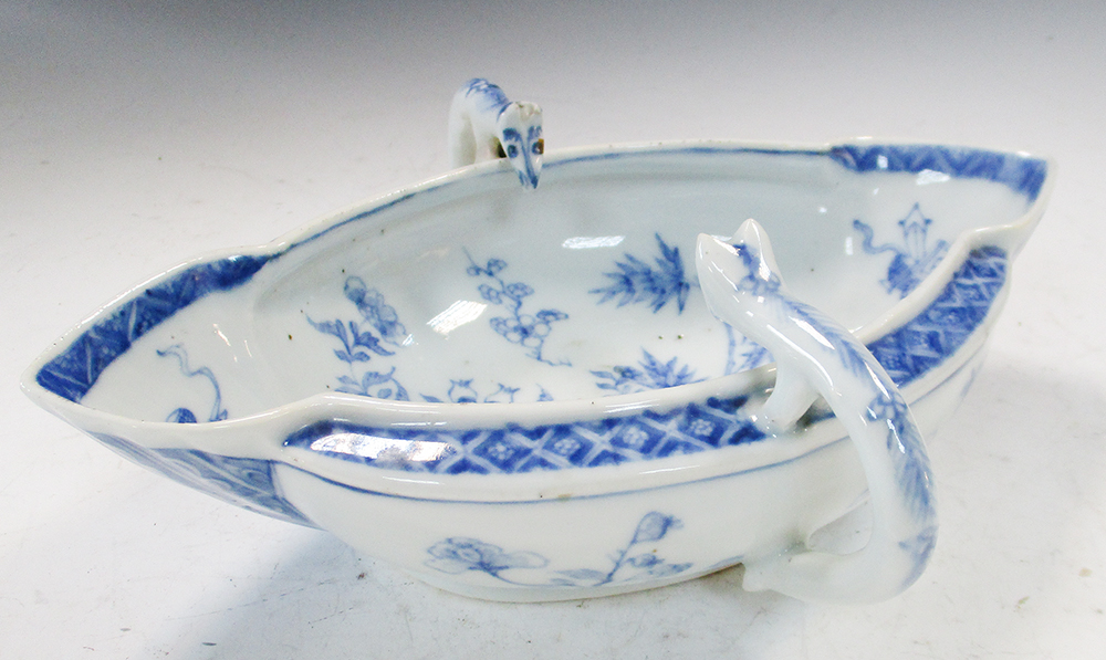 An 18th century blue and white double lipped sauce boat, the head terminals looking into the