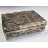 An early 20th century silver double cigarette box, the rectangular hinged lid and sides cast in