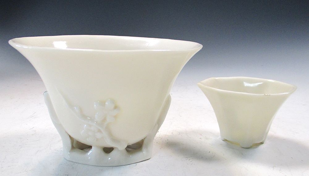 An 18th century blanc de Chine libation cup and another smaller octagonal, the oval rim above sprigs