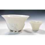 An 18th century blanc de Chine libation cup and another smaller octagonal, the oval rim above sprigs