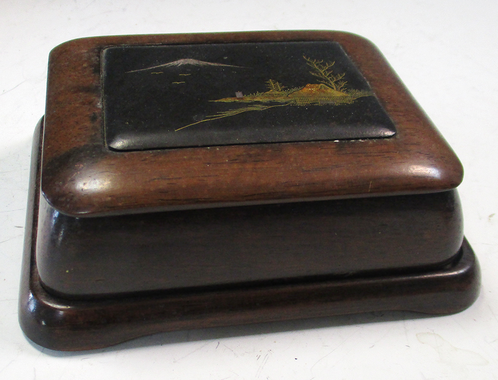 An early 20th century hardwood box with Komai style inlaid iron panel, the rectangular panel