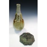 A studio stoneware bottle vase together with a Han style bronze mirror, the bottle in the form of an