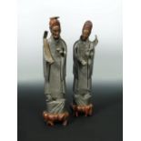 A pair of pewter figures, possibly late 19th/early 20th century, the standing men wearing red
