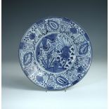 A 17th century Arita kraak dish, the central rock and flower enclosed by radiating panels, 32xm (