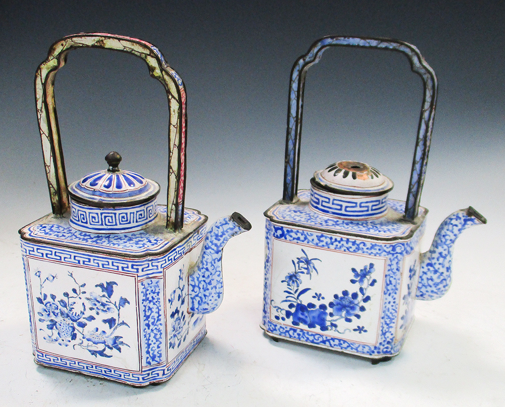 Two similar late 18th/early 19th century enamel wine ewers and covers, both with handles raised over