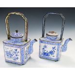 Two similar late 18th/early 19th century enamel wine ewers and covers, both with handles raised over