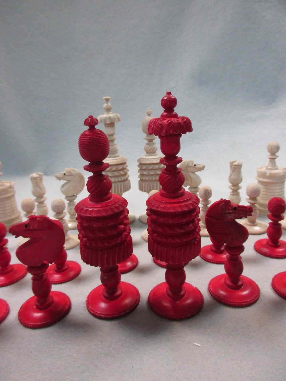 A 19th century red and white bone chess set, each piece ring turned with gadroons and flutes, the - Image 3 of 3