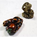 A monkey and peach ivory netsuke and an octopus and monkey netsuke, the first stained brown, the