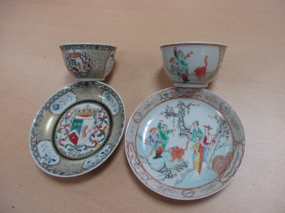 An armorial tea bowl and saucer and another famille rose, the first bearing the arms of the Dutch