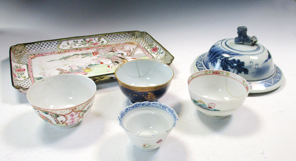 An 18th century enamel tray, four tea bowls and a blue and white cover, the tray painted with an