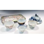 An 18th century enamel tray, four tea bowls and a blue and white cover, the tray painted with an