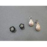 A pair of diamond earstuds with removable black onyx flowerhead collars, together with a pair of