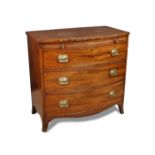 A Regency mahogany bow front chest with brushing slide, the baize lined slide above three long