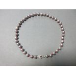 A ruby, diamond and cultured grey pearl necklace, composed of uniform 9mm dove grey pearls