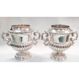 A pair of electroplated two handled wine coolers, each of half gadrooned body on a circular foot,